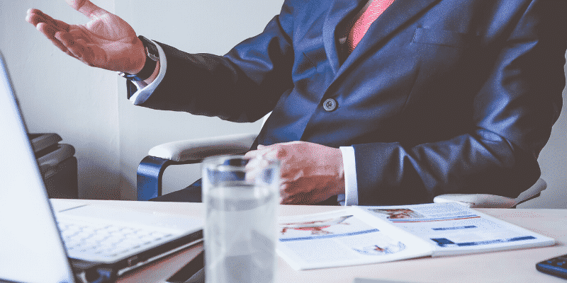 man-in-suit-sitting-at-desk